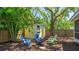 Well-maintained backyard with a storage shed and comfortable seating around a fire pit at 4721 Garcia Ave, Sarasota, FL 34233