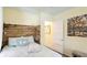 Comfortable bedroom with wooden headboard, soft lighting, and doorway to bathroom at 4721 Garcia Ave, Sarasota, FL 34233
