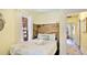 Serene bedroom showcases wooden headboard, and doorway to bathroom at 4721 Garcia Ave, Sarasota, FL 34233