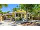 Yellow house with a cozy front porch, well-kept landscaping, and convenient carport at 4721 Garcia Ave, Sarasota, FL 34233