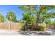 A private fenced-in front yard with mature trees and lush greenery at 4721 Garcia Ave, Sarasota, FL 34233