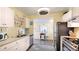 Bright kitchen with stainless steel appliances, white cabinets, and open to the dining area at 4721 Garcia Ave, Sarasota, FL 34233
