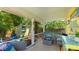 Inviting porch with comfortable seating, overlooking the lush backyard and a charming storage shed at 4721 Garcia Ave, Sarasota, FL 34233