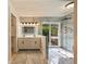 Bathroom boasts a double vanity, luxurious shower with a glass door, and views of the outdoor foliage at 4916 Hidden Oaks Trl, Sarasota, FL 34232