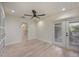 Bright bedroom with light wood floors and doors leading outside at 4916 Hidden Oaks Trl, Sarasota, FL 34232