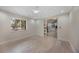 Bright bedroom with light hardwood floors and access to a kitchen area at 4916 Hidden Oaks Trl, Sarasota, FL 34232