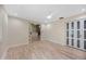 Bright bedroom featuring light hardwood floors, textured ceilings, and walk-in closet at 4916 Hidden Oaks Trl, Sarasota, FL 34232