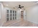 Bright bedroom with light wood floors and a view to another area of the house at 4916 Hidden Oaks Trl, Sarasota, FL 34232