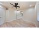 Bedroom with light wood floors and a view to another area of the house at 4916 Hidden Oaks Trl, Sarasota, FL 34232