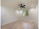 Bedroom with light wood floors and view of the surrounding landscaping at 4916 Hidden Oaks Trl, Sarasota, FL 34232