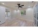 Bright bedroom with light wood floors and view of the surrounding landscaping at 4916 Hidden Oaks Trl, Sarasota, FL 34232