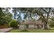 Beautiful home featuring manicured landscaping and a spacious driveway with ample parking at 4916 Hidden Oaks Trl, Sarasota, FL 34232