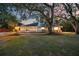 Inviting single-story home boasting manicured lawns and mature, picturesque shade trees at 4916 Hidden Oaks Trl, Sarasota, FL 34232