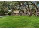 Spacious front lawn and mature trees give this house curb appeal at 4916 Hidden Oaks Trl, Sarasota, FL 34232