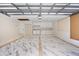 Well-lit two car garage with custom flooring, built-in cabinets, and a designated laundry area at 4916 Hidden Oaks Trl, Sarasota, FL 34232