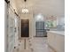 Bright kitchen with modern appliances, white cabinetry, and an accent barn door at 4916 Hidden Oaks Trl, Sarasota, FL 34232