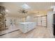 Open concept kitchen with a large island, skylight, and modern lighting fixtures at 4916 Hidden Oaks Trl, Sarasota, FL 34232