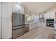 Bright kitchen featuring white cabinets, stainless steel appliances, and an undermount sink at 4916 Hidden Oaks Trl, Sarasota, FL 34232