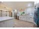Bright kitchen featuring white cabinets and countertops, plus stainless steel appliances at 4916 Hidden Oaks Trl, Sarasota, FL 34232