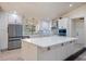 Bright, modern kitchen with white cabinetry, stainless steel appliances, and a large island at 4916 Hidden Oaks Trl, Sarasota, FL 34232