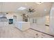 Spacious open floor plan with a stone fireplace and abundant natural light from the skylight at 4916 Hidden Oaks Trl, Sarasota, FL 34232