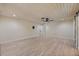 Open living space with light wood floors and modern lighting, leading to other areas of the home at 4916 Hidden Oaks Trl, Sarasota, FL 34232