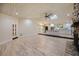 Open living space featuring a stone fireplace, vaulted ceilings, and a seamless transition to the kitchen at 4916 Hidden Oaks Trl, Sarasota, FL 34232