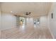 Spacious living room with sliding barn doors leading to the outside and double doors to another room at 4916 Hidden Oaks Trl, Sarasota, FL 34232