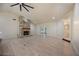 Spacious living room with a stone fireplace, wooden floors, and access to the backyard at 4916 Hidden Oaks Trl, Sarasota, FL 34232
