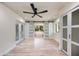Bright bedroom with sliding barn doors, an outside view, and a soaking tub in the connecting bathroom at 4916 Hidden Oaks Trl, Sarasota, FL 34232