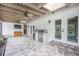 Outdoor patio with a built-in grill, ceiling fans and stone flooring, ideal for entertaining guests at 4916 Hidden Oaks Trl, Sarasota, FL 34232