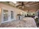 This patio features an outdoor kitchen, seating area, and brick flooring at 4916 Hidden Oaks Trl, Sarasota, FL 34232