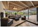 This covered patio has a brick floor and outdoor seating area overlooking the pool at 4916 Hidden Oaks Trl, Sarasota, FL 34232