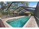 Spacious screened-in pool with poolside seating and clear water at 4916 Hidden Oaks Trl, Sarasota, FL 34232