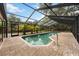 Enclosed swimming pool featuring a brick deck and screened enclosure at 4916 Hidden Oaks Trl, Sarasota, FL 34232