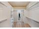 Well-organized walk-in closet featuring custom shelving and drawer systems, complemented by wooden floors at 4916 Hidden Oaks Trl, Sarasota, FL 34232
