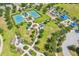 Aerial shot of community amenities including tennis courts, a splash pad, a playground, and green spaces at 5023 Brickell Park Cv, Bradenton, FL 34211