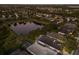 Aerial shot showcases a desirable community with lush landscaping, a pond, and homes with private pools at 5023 Brickell Park Cv, Bradenton, FL 34211