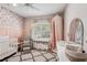 Charming Bedroom featuring a crib, accent wall, and a cozy sitting area at 5023 Brickell Park Cv, Bradenton, FL 34211