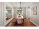 Sunlit dining room with a long table and bench seating, perfect for Gathering gatherings at 5023 Brickell Park Cv, Bradenton, FL 34211
