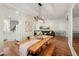 Open-concept dining area seamlessly connects to the living room, featuring a long wooden table and stylish decor at 5023 Brickell Park Cv, Bradenton, FL 34211
