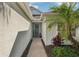 Welcoming front entrance featuring a cozy bench, decorative plants, and a charming blue door at 5023 Brickell Park Cv, Bradenton, FL 34211