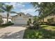 Beautiful home with a two-car garage, lush landscaping and sidewalk to the front door at 5023 Brickell Park Cv, Bradenton, FL 34211