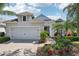 Charming single-Gathering home featuring a manicured lawn with lush landscaping and a welcoming driveway at 5023 Brickell Park Cv, Bradenton, FL 34211