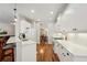 White kitchen featuring hardwood floors, white cabinets, and stainless steel appliances at 5023 Brickell Park Cv, Bradenton, FL 34211