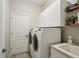 Bright laundry room with a modern washer and dryer, white cabinetry and neutral paint at 5023 Brickell Park Cv, Bradenton, FL 34211