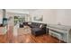 Open living area featuring hardwood floors, a sectional couch, and a piano for entertaining at 5023 Brickell Park Cv, Bradenton, FL 34211