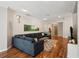 Spacious living room with hardwood floors, a large sofa and a neutral color palette at 5023 Brickell Park Cv, Bradenton, FL 34211