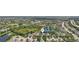 An aerial shot shows a dense neighborhood with lush landscaping, water features, and well-maintained homes at 5023 Brickell Park Cv, Bradenton, FL 34211