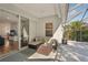Enclosed patio area with comfortable seating, a ceiling fan, and views of the backyard at 5023 Brickell Park Cv, Bradenton, FL 34211